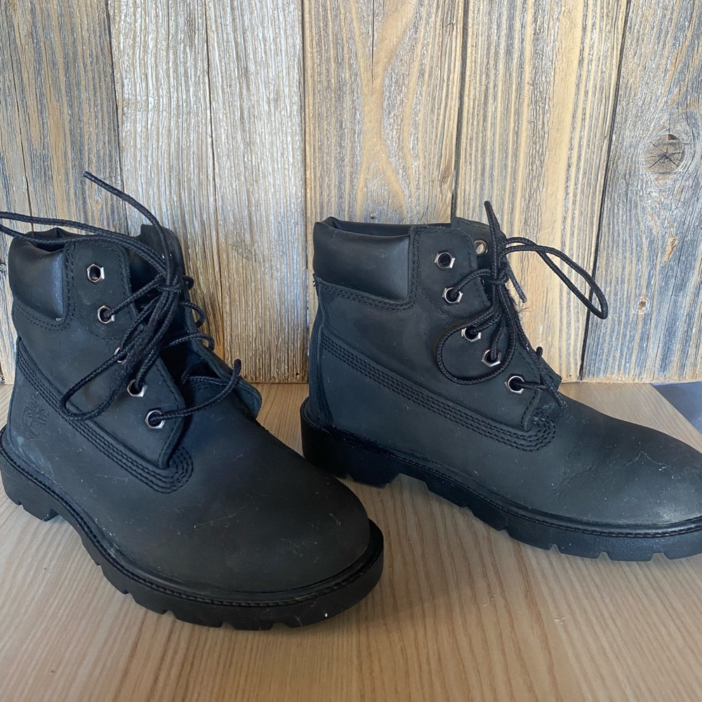 Two pairs of boys shoes - Size 1. Timberland boots and Underarmour tennis shoes.